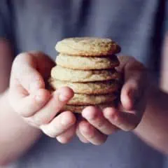 person holding brown cookies in close up photography