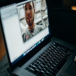 Photo by cottonbro studio Close-up of a person engaged in a video call on a laptop indoors, showcasing modern technology.