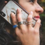 Photo by Patty Zavala woman wearing gold ring holding silver iphone 6