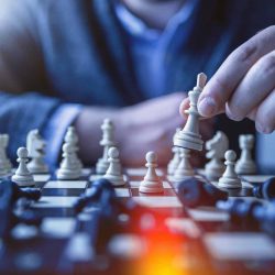 depth of field photography of man playing chess