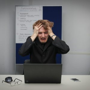 Photo by Sebastian Herrmann A man sitting in front of a laptop computer