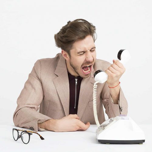 man holding telephone screaming