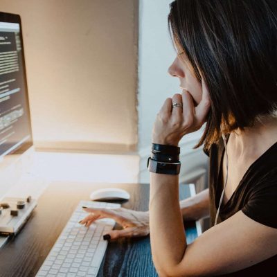 woman wearing black t-shirt holding white computer keyboard